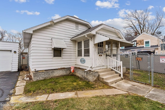 view of front of home with a gate, roof with shingles, and fence