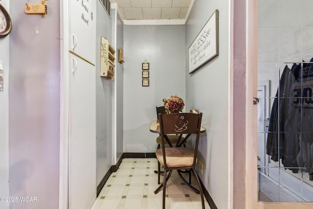 corridor with light floors and baseboards