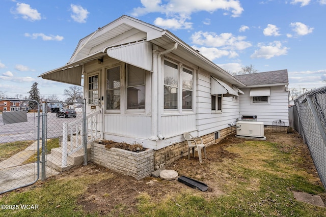 view of property exterior featuring a gate and fence