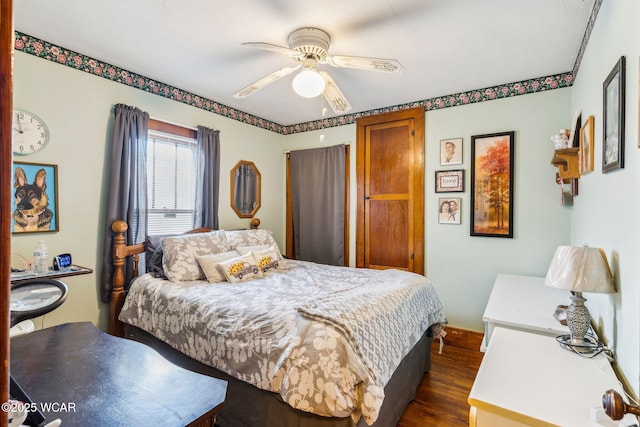 bedroom with dark wood-type flooring and a ceiling fan