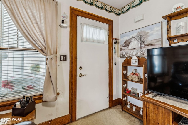 foyer featuring light colored carpet