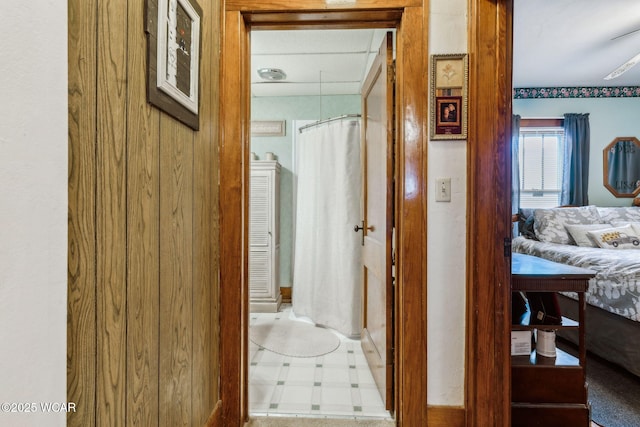 hall with tile patterned floors