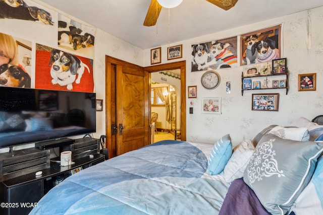 bedroom featuring a ceiling fan and arched walkways