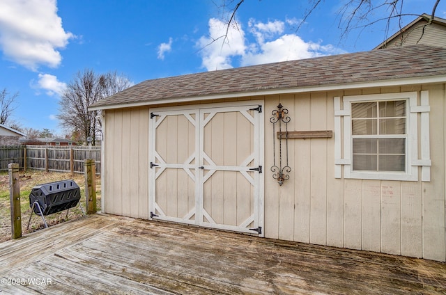 view of shed featuring fence