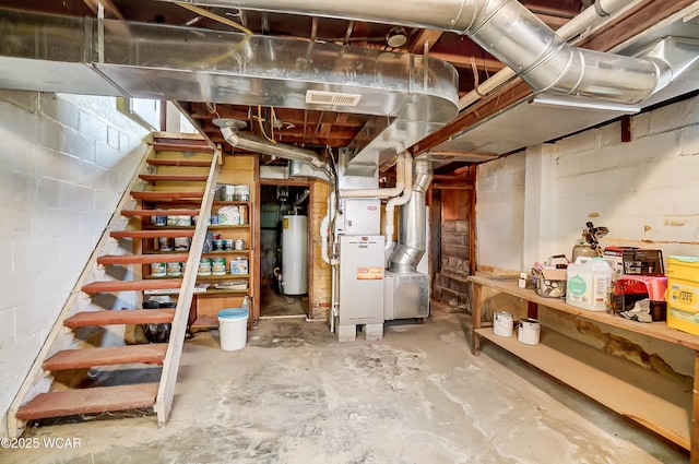 unfinished basement featuring gas water heater, heating unit, visible vents, and stairway