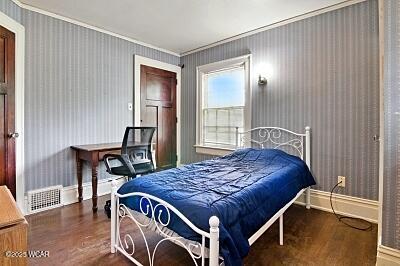 402 S Woodlawn Ave, Lima, OH 45805 - bedroom featuring ornamental molding, wood finished floors, and baseboards