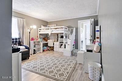 402 S Woodlawn Ave, Lima, OH 45805 - bedroom with a textured ceiling and wood finished floors