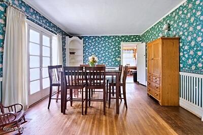 402 S Woodlawn Ave, Lima, OH 45805 - dining space with wallpapered walls and wood finished floors