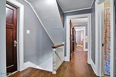 402 S Woodlawn Ave, Lima, OH 45805 - corridor featuring an upstairs landing, wood finished floors, baseboards, and crown molding