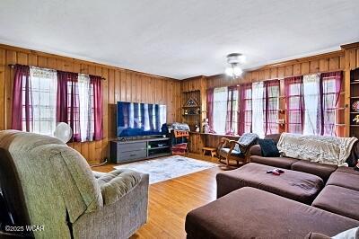 402 S Woodlawn Ave, Lima, OH 45805 - living area featuring wooden walls, healthy amount of natural light, and light wood-type flooring