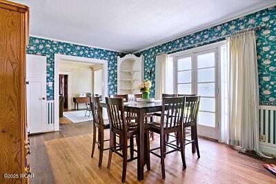 402 S Woodlawn Ave, Lima, OH 45805 - dining space with wallpapered walls and wood finished floors