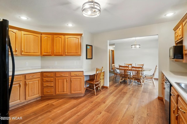1330 Christina St, Delphos, OH 45833 - kitchen featuring freestanding refrigerator, light countertops, light wood-style floors, brown cabinetry, and recessed lighting