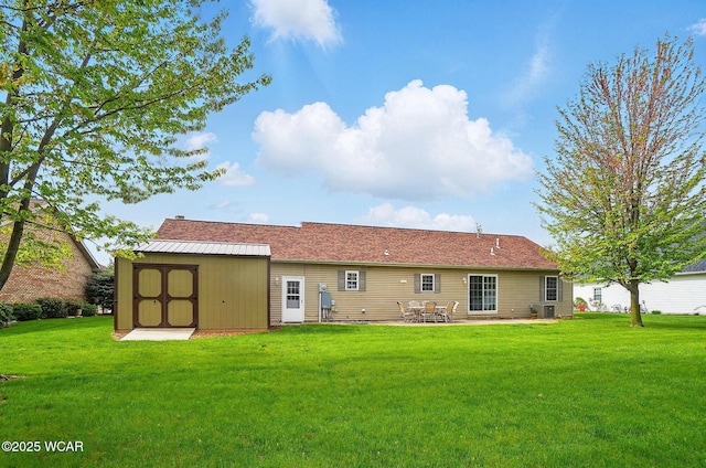 1330 Christina St, Delphos, OH 45833 - rear view of house featuring a yard, a patio area, an outbuilding, a storage shed, and central AC