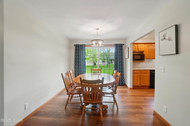 1330 Christina St, Delphos, OH 45833 - dining area featuring a chandelier, wood finished floors, and baseboards
