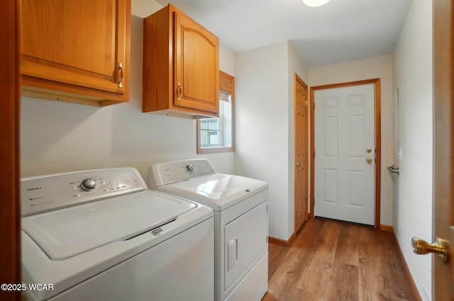 1330 Christina St, Delphos, OH 45833 - clothes washing area featuring independent washer and dryer, cabinet space, light wood-style flooring, and baseboards