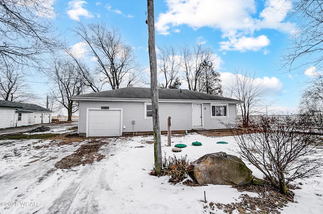 snow covered property featuring a garage