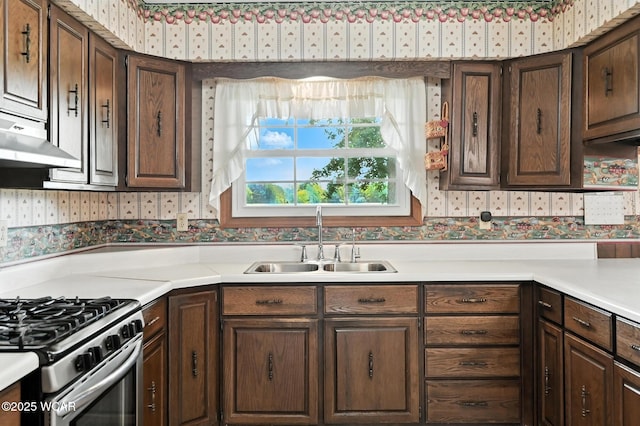 10815 Holdgreve Rd, Delphos, OH 45833 - kitchen featuring wallpapered walls, gas range, light countertops, and dark brown cabinets