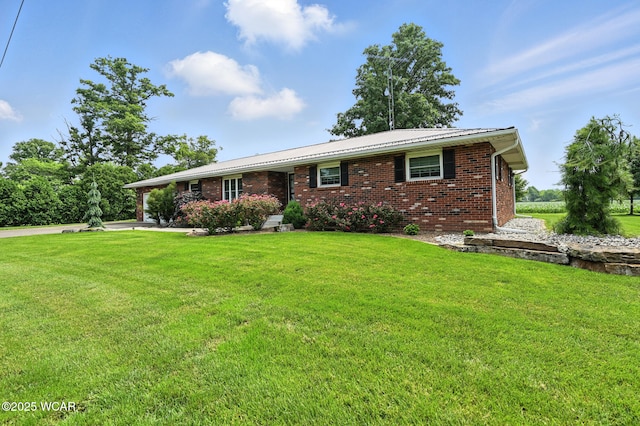10815 Holdgreve Rd, Delphos, OH 45833 - single story home with brick siding, a front yard, and a metal roof