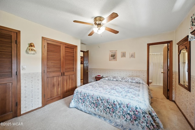10815 Holdgreve Rd, Delphos, OH 45833 - bedroom with light colored carpet, wainscoting, a textured ceiling, and ceiling fan
