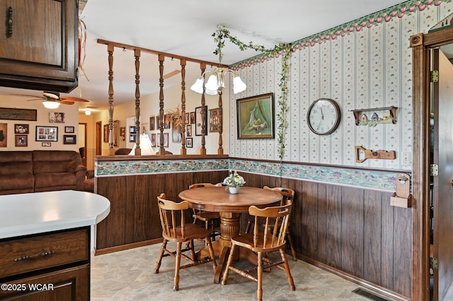 10815 Holdgreve Rd, Delphos, OH 45833 - dining space with a wainscoted wall, wallpapered walls, and ceiling fan
