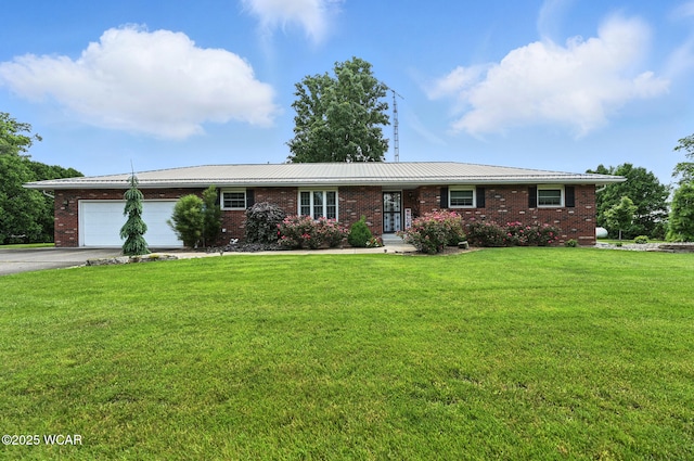 10815 Holdgreve Rd, Delphos, OH 45833 - ranch-style house featuring brick siding, concrete driveway, and a garage