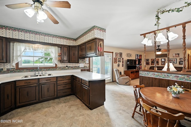10815 Holdgreve Rd, Delphos, OH 45833 - kitchen with a ceiling fan, open floor plan, light countertops, and dark brown cabinetry