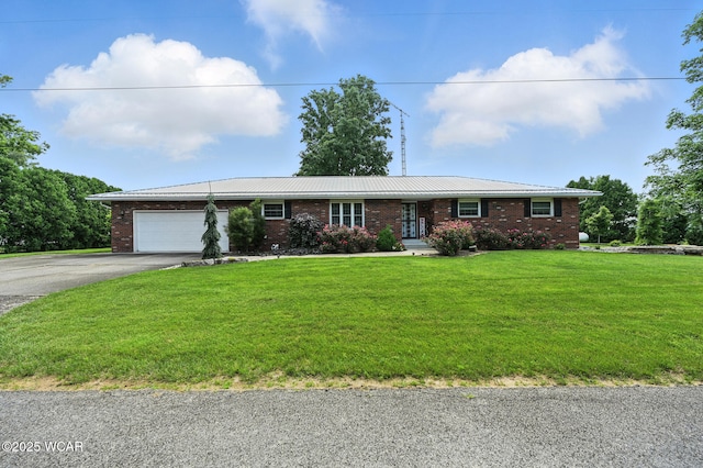 10815 Holdgreve Rd, Delphos, OH 45833 - ranch-style house with brick siding, asphalt driveway, a garage, and a front yard