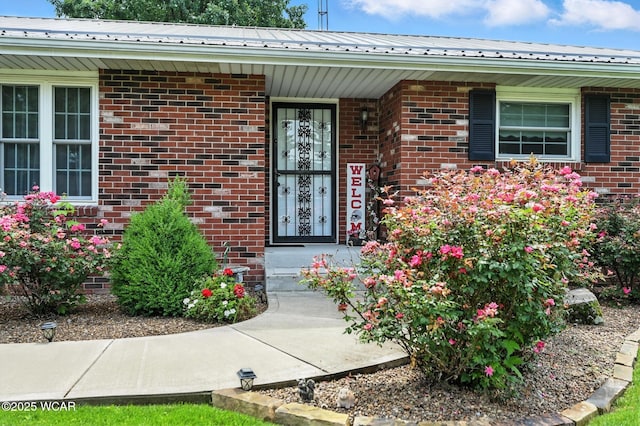 10815 Holdgreve Rd, Delphos, OH 45833 - property entrance with brick siding, a metal roof, and covered porch