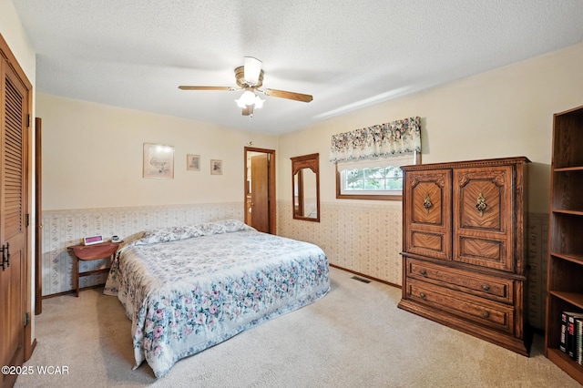 10815 Holdgreve Rd, Delphos, OH 45833 - bedroom with light colored carpet, wallpapered walls, a closet, and ceiling fan