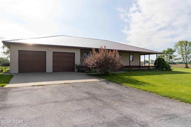 14351 Rd 19, Fort Jennings, OH 45844 - view of front of house featuring an attached garage, asphalt driveway, a front yard, and metal roof