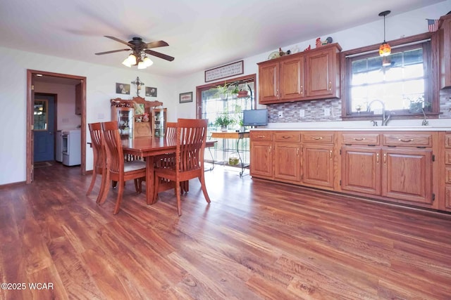 14351 Rd 19, Fort Jennings, OH 45844 - dining room featuring wood finished floors, a ceiling fan, and separate washer and dryer