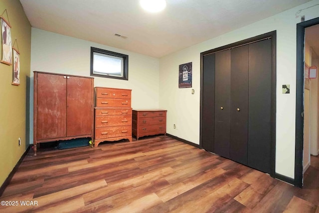 14351 Rd 19, Fort Jennings, OH 45844 - unfurnished bedroom with wood finished floors, baseboards, and a closet