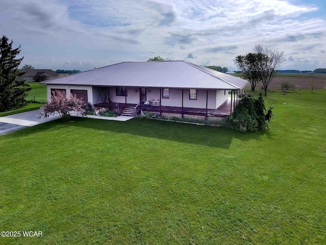 14351 Rd 19, Fort Jennings, OH 45844 - view of front of property featuring a garage, asphalt driveway, a front lawn, covered porch, and metal roof