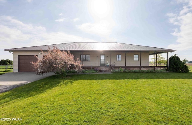 14351 Rd 19, Fort Jennings, OH 45844 - farmhouse-style home with driveway, a garage, covered porch, and a front yard