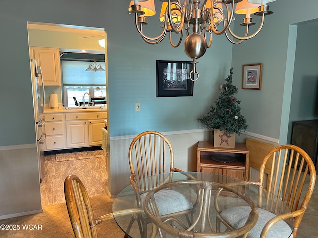 3031 Yoakam Rd, Lima, OH 45806 - dining space featuring a chandelier, a wainscoted wall, and light colored carpet