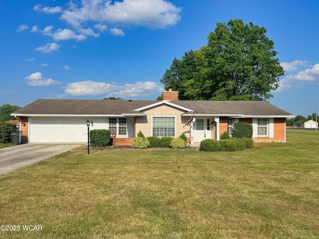 3031 Yoakam Rd, Lima, OH 45806 - ranch-style house featuring an attached garage, driveway, brick siding, and a front yard