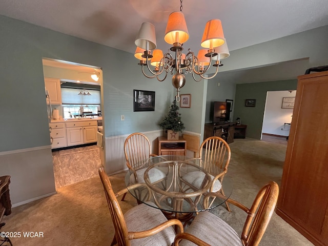 3031 Yoakam Rd, Lima, OH 45806 - dining space with light carpet, a chandelier, and wainscoting