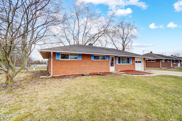 ranch-style house featuring brick siding, an attached garage, a front yard, fence, and driveway