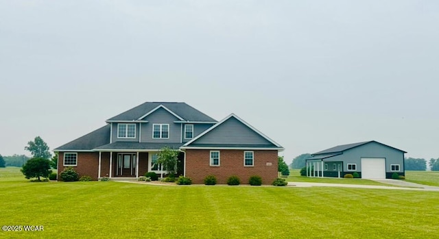1640 Olt Rd, Columbus Grove, OH 45830 - view of front of home featuring concrete driveway, an outdoor structure, a front lawn, and brick siding