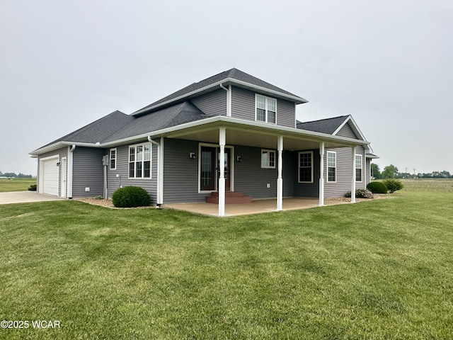 1640 Olt Rd, Columbus Grove, OH 45830 - back of house featuring a yard, an attached garage, driveway, and a shingled roof