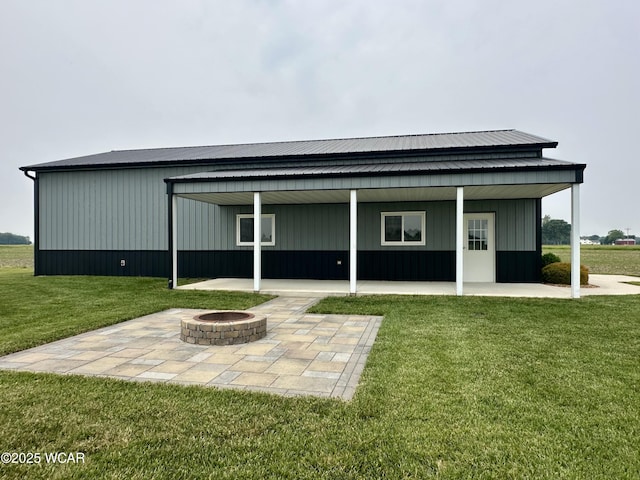 1640 Olt Rd, Columbus Grove, OH 45830 - back of house with an outdoor fire pit, a lawn, and a patio