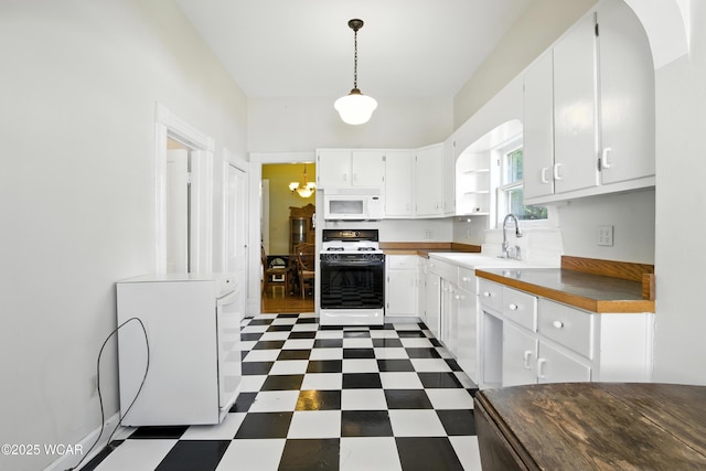302 N Market St, Van Wert, OH 45891 - kitchen featuring white appliances, dark floors, open shelves, and white cabinetry