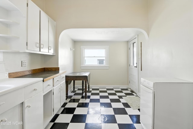 302 N Market St, Van Wert, OH 45891 - kitchen featuring dark floors, white cabinetry, open shelves, and arched walkways