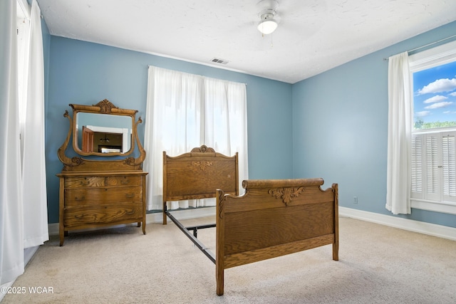 302 N Market St, Van Wert, OH 45891 - bedroom featuring multiple windows, carpet floors, and a ceiling fan