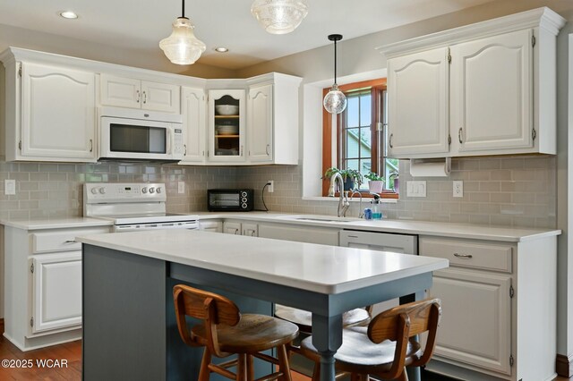 4860 Wenatchi Trl, Lima, OH 45805 - kitchen featuring white appliances, white cabinets, light countertops, tasteful backsplash, and recessed lighting
