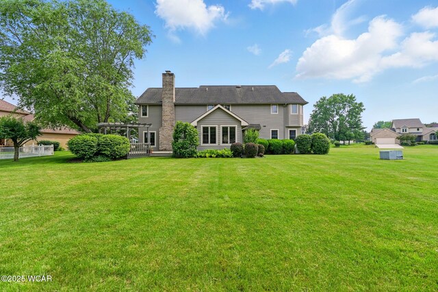 4860 Wenatchi Trl, Lima, OH 45805 - back of house featuring a chimney, a yard, and a pergola