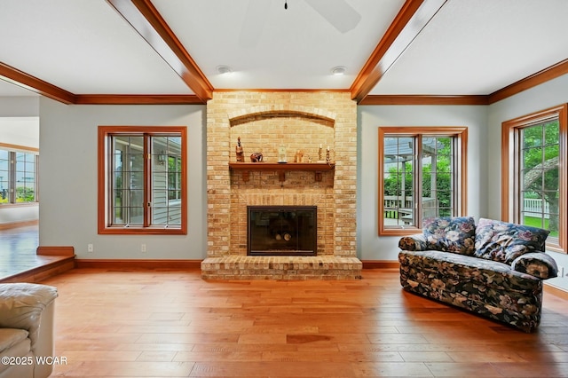 4860 Wenatchi Trl, Lima, OH 45805 - living area with ornamental molding, ceiling fan, wood-type flooring, a fireplace, and beamed ceiling