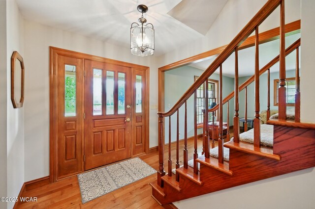 4860 Wenatchi Trl, Lima, OH 45805 - foyer entrance featuring hardwood / wood-style flooring, stairway, and a chandelier