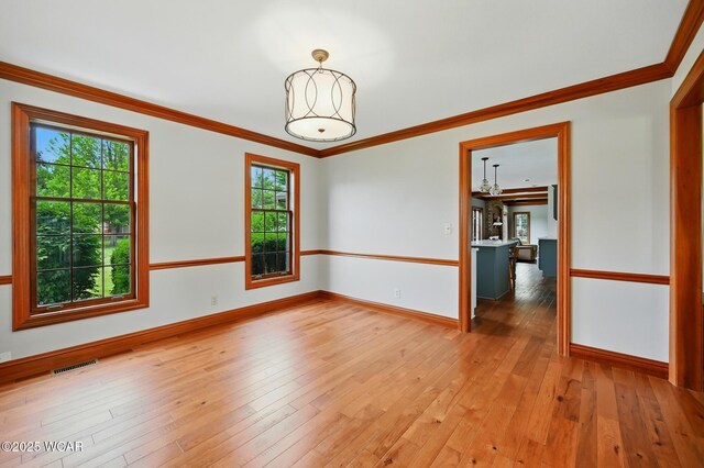 4860 Wenatchi Trl, Lima, OH 45805 - spare room featuring light wood-style flooring and crown molding