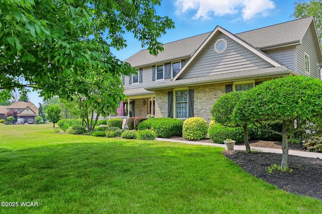 4860 Wenatchi Trl, Lima, OH 45805 - view of front of house with a front lawn, brick siding, and roof with shingles